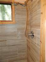 tiled shower with cedar door